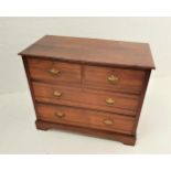 EDWARDIAN WALNUT CHEST with a moulded top above two short and two long drawers, standing on