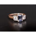 BLUE AND WHITE SAPPHIRE THREE STONE RING the central blue sapphire flanked by a round cut white