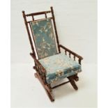 EDWARDIAN ROCKING CHAIR with ring turned decoration and a padded back with matching seat cushion, on