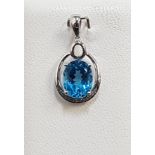 BLUE TOPAZ AND DIAMOND PENDANT the central oval cut blue topaz approximately 2.5cts with illusion