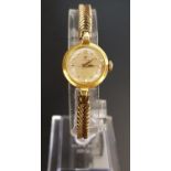 LADIES EIGHTEEN CARAT GOLD CASED OMEGA WRISTWATCH the dial with five minute markers, the seventeen