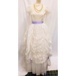 IVORY BALLGOWN - UNKNOWN PRODUCTION the dress with lace and purple ribbon detail, with layered skirt
