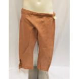 PAIR OF SALMON COLOURED CANVAS TROUSERS - UNKNOWN PRODUCTION with tie detail and with Western