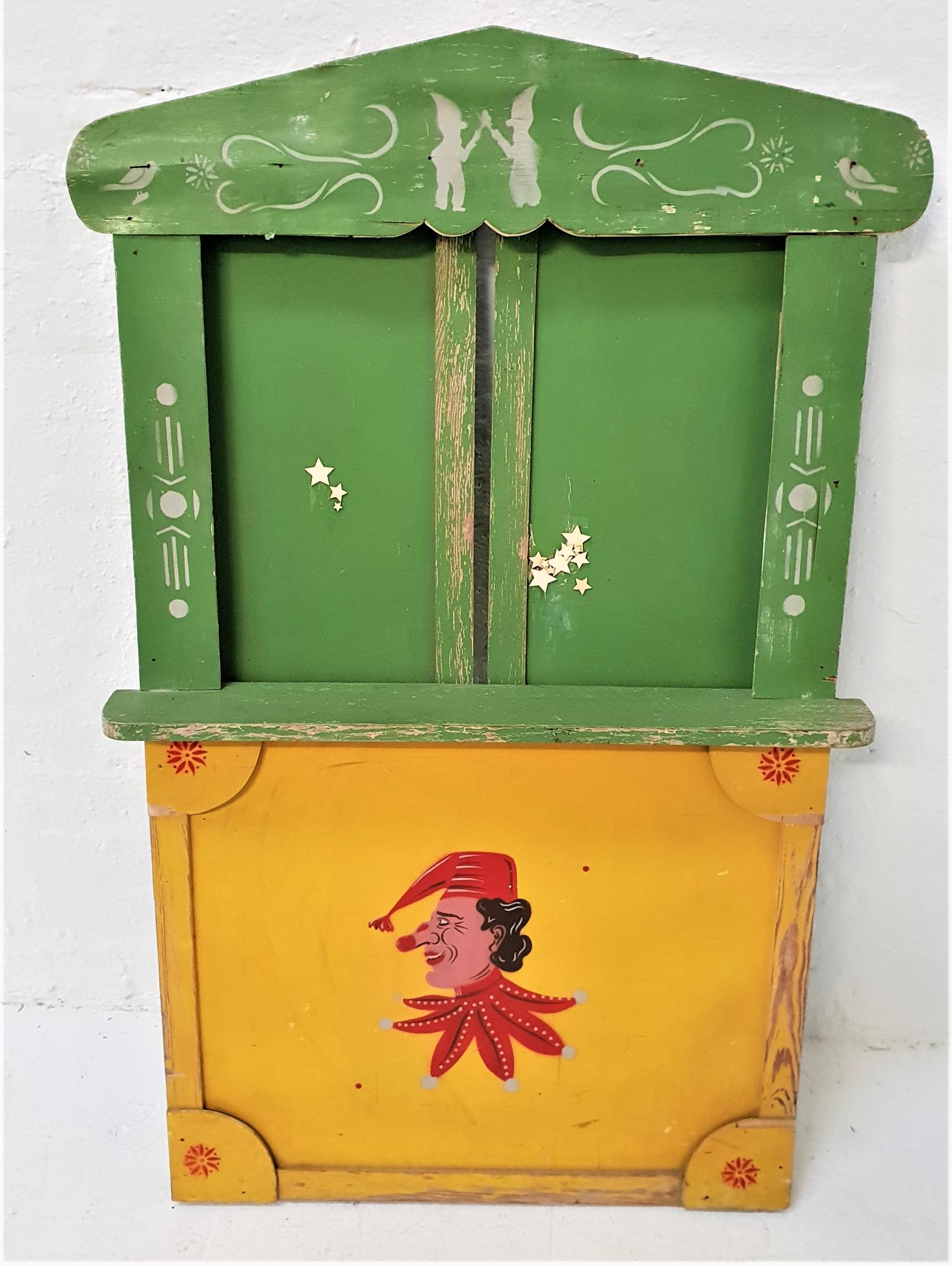 CHILDRENS WOODEN PUNCH AND JUDY THEATRE STAND with a shaped painted and stenciled front panel with