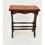 EDWARDIAN MAHOGANY ORGAN STOOL with an oblong sloping seat on shaped and carved supports united by