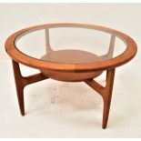 STONEHILL TEAK OCCASIONAL TABLE with a circular glass inset top standing on four shaped supports