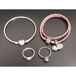 SELECTION OF PANDORA JEWELLERY comprising a Moments silver charm bracelet with heart-shaped clasp; a