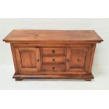 TEAK SIDEBOARD with a plain rectangular top above three central drawers flanked by a pair of
