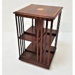 EDWARDIAN MAHOGANY AND INLAID REVOLVING BOOKCASE with open and slatted sides on a rotating base,