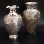 TWO SMALL SILVER FLOWER VASES the frilly rimmed example with embossed and engraved floral