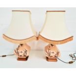 PAIR OF SHAPED POTTERY TABLE LAMPS raised on square bases, with crackle effect glaze and decorated