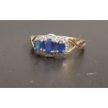 SAPPHIRE AND DIAMOND RING the three graduated oval cut sapphires in diamond surround, on nine