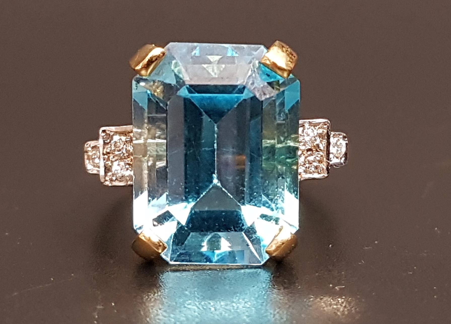 BLUE TOPAZ AND DIAMOND COCKTAIL RING the large emerald cut blue topaz measuring approximately 15.4mm