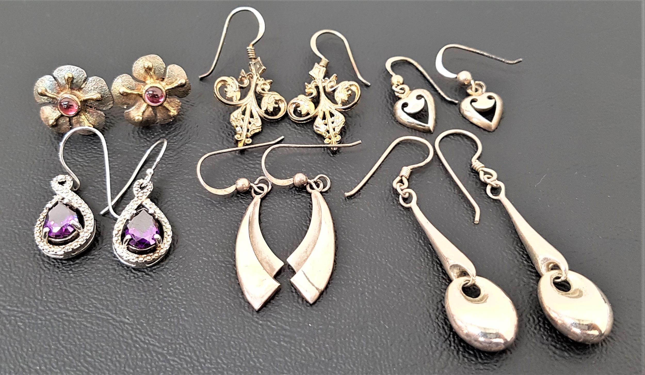 SIX PAIRS OF SILVER EARRINGS including a pair of purple CZ set drop earrings, a pair of cabochon gem