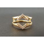 UNUSUAL DIAMOND SET RING the diamonds in opposing chevron shaped setting around a pierced centre, in