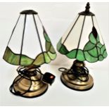 PAIR OF TIFFANY STYLE TABLE LAMPS with opaque green and off white shades, on brass basses, 35cm high