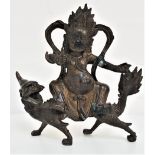 CHINESE BRONZE GROUP depicting a deity riding on the back of the mythical Qilin, 20cm high