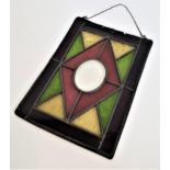 STAINED GLASS PANE of rectangular form with an outer band of claret with green and yellow