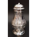 GEORGE II SILVER SUGAR SIFTER of baluster form with embossed decoration, raised on a circular