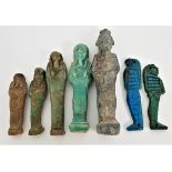 FIVE EGYPTIAN GRADUATED FAIENCE USHABTI one with carved hieroglyphs, 7cm-12.5cm high, together