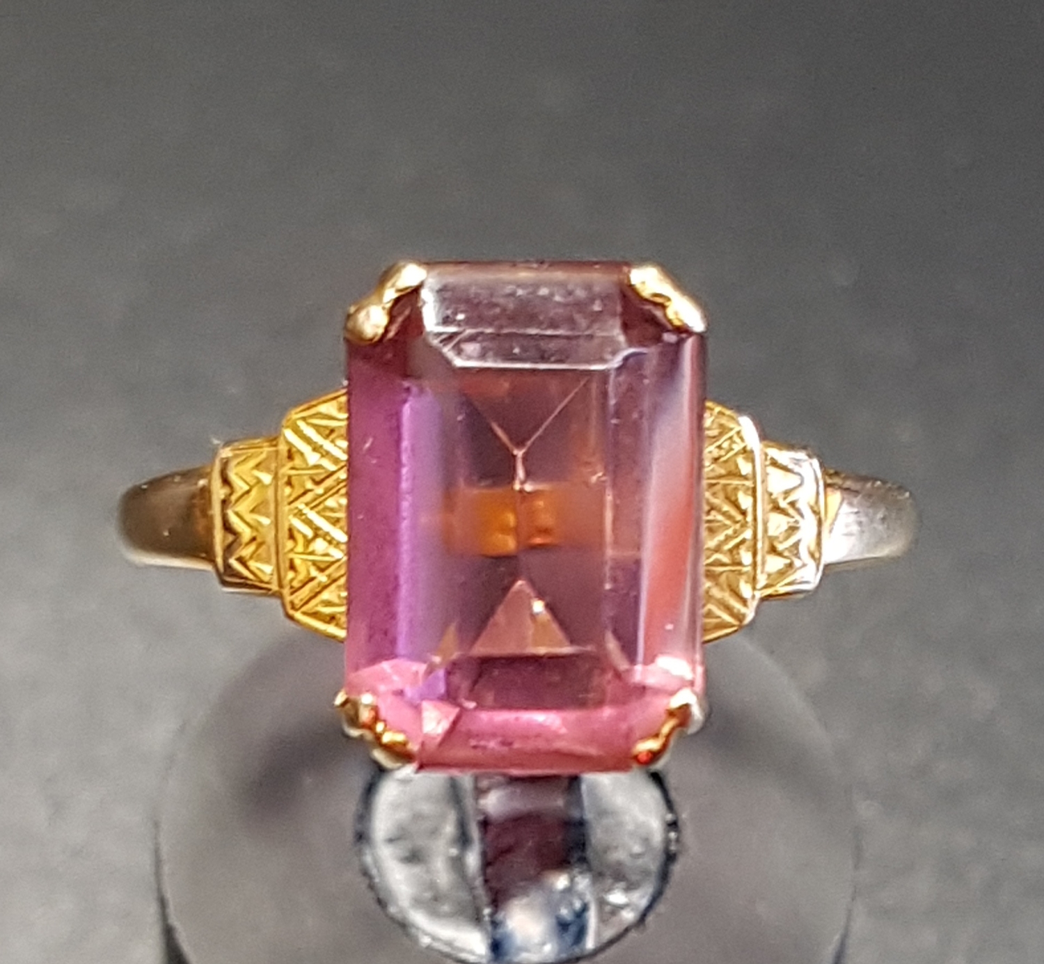PINK GEM SET SINGLE STONE RING on nine carat gold shank with stepped shoulders, ring size P