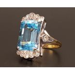 IMPRESSIVE BLUE TOPAZ AND DIAMOND COCKTAIL RING the large emerald cut blue topaz measuring