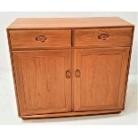 ERCOL LIGHT OAK SIDE CABINET with a moulded top above two frieze drawers with a pair of panelled