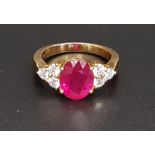 IMPRESSIVE RUBY AND DIAMOND RING the large central oval cut treated ruby approximately 4.5cts