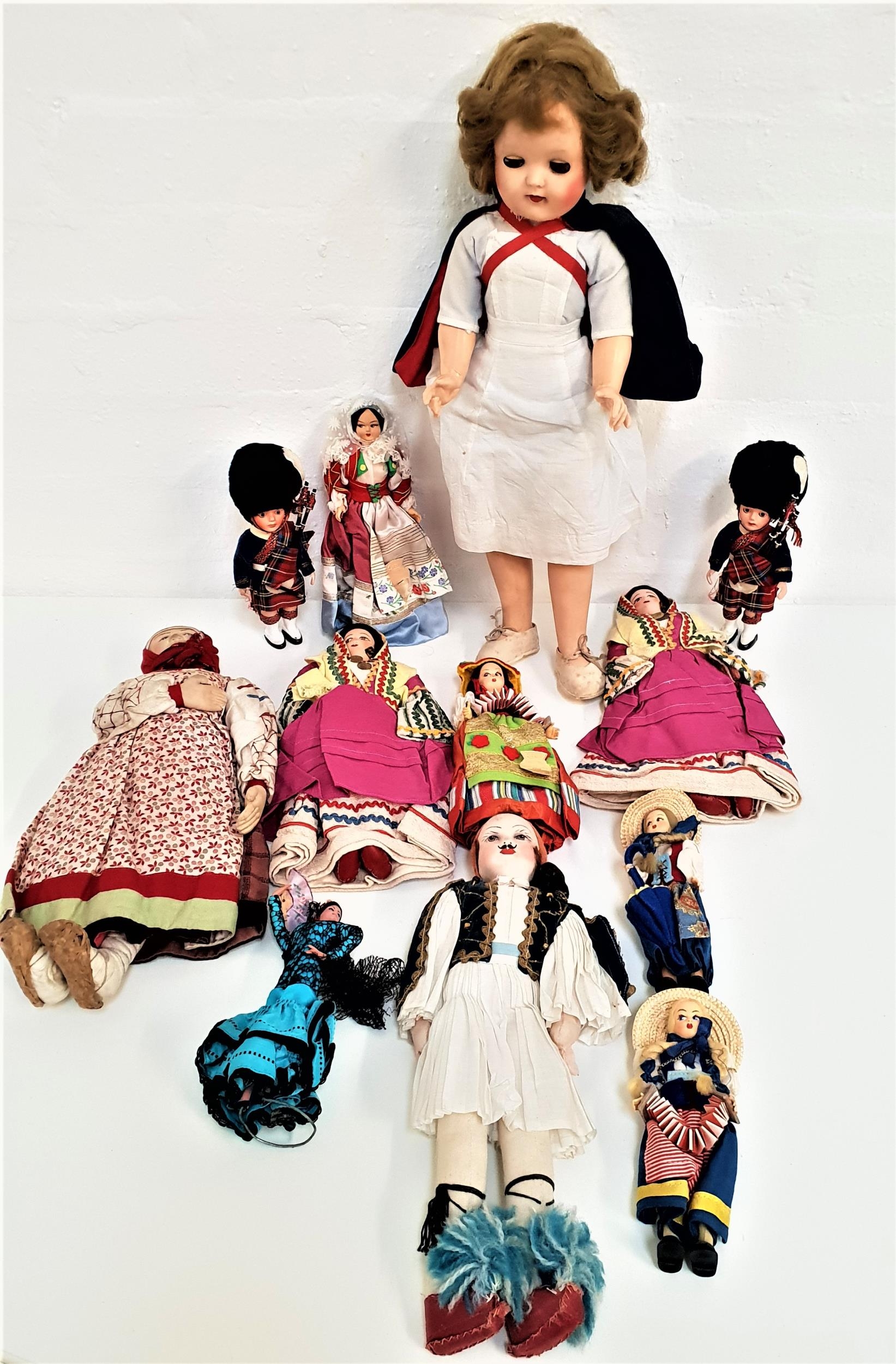 SELECTION OF WORLD DOLLS some with porcelain heads and in traditional dress, with examples from