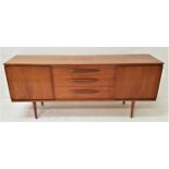 RETRO TEAK SIDEBOARD with a plain top above three central drawers with torpedo shaped handles,