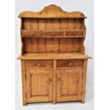 WAXED PINE DRESSER with shaped top and sides, with two shelves and three drawers above a base with