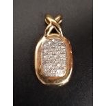 PAVE SET DIAMOND PENDANT of oval form with 'X' shaped suspension loop, in fourteen carat gold,