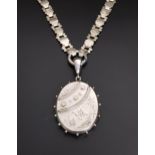 VICTORIAN UNMARKED SILVER LOCKET PENDANT with engraved bird, floral and motif decoration, on heavy