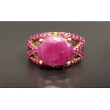 RUBY DRESS RING the large central oval cut ruby approximately 4.5cts in ruby set pierced setting, on