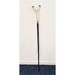 HAZEL WALKING STICK with an antler Y shaped handle above a silver collar engraved with a stags head,