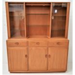 ERCOL LIGHT OAK ILLUMINATED SIDE CABINET with a moulded top above a central recess with adjustable