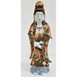 LARGE JAPANESE PORCELAIN SATSUMA FIGURE OF KANNON dressed in flowing robes, with her hands crossed