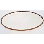 METAL FRAME OVAL WALL MIRROR surmounted with a bow, with a bevelled oval plate, 75cm wide