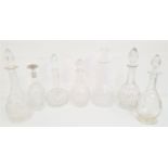 SEVEN CRYSTAL AND CUT GLASS DECANTERS of various designs, all with stoppers (7)