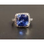 TANZANITE AND DIAMOND CLUSTER DRESS RING the central cushion cut tanzanite measuring approximately