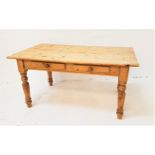 WAXED PINE FARMHOUSE TABLE with a plain top above two frieze drawers, standing on turned supports,