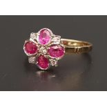 RUBY AND DIAMOND CLUSTER RING the four oval cut rubies separated by small diamonds, on eighteen