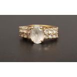 QUARTZ DRESS RING the central oval cut gemstone flanked by two rows of smaller quartz gemstones,