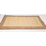 LARGE RUG the camel and cream ground with square motifs to the central section, 323cm x 172cm