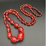 GRADUATED AMBER BEAD NECKLACE with individually knotted beads, approximately 100cm long and 58.2