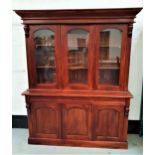 TEAK ILLUMINATED SIDE CABINET with a moulded cornice above three arched glass panel doors opening to