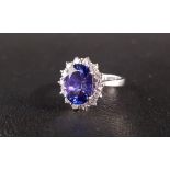 IMPRESSIVE TANZANITE AND DIAMOND CLUSTER RING the central oval cut tanzanite approximately 4cts,