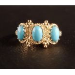 TURQUOISE THREE STONE RING the three oval cabochon turquoise stones in decorative moulded setting,
