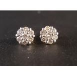 PRETTY PAIR OF DIAMOND CLUSTER EARRINGS each earring with a central diamond surrounded by six