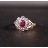 RUBY AND DIAMOND CLUSTER RING the central round cut ruby approximately 0.45cts, in eight diamond